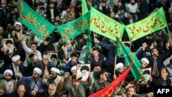 Iranians chant slogans as they march in support of the government near the Imam Khomeini grand mosque in the capital Tehran, Dec. 30, 2017.