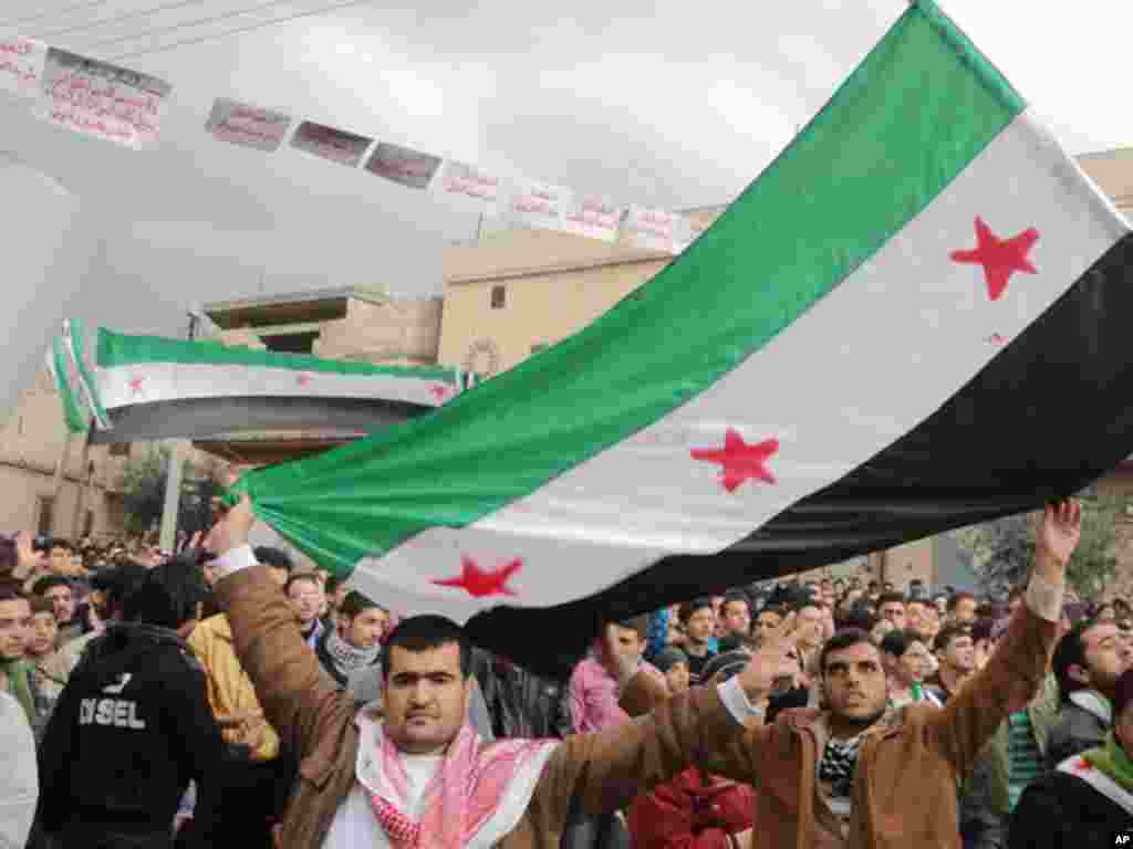 Demonstrators take part in a protest against Syria's President Bashar al-Assad after Friday prayer in Talbiseh near Homs January 13, 2012. (Reuters)