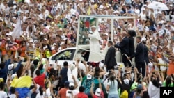 People greet Pope Francis as he arrives to celebrate Mass in Villavicencio, Colombia, Sept. 8, 2017.