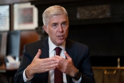 FILE - Justice Neil Gorsuch speaks during an interview in his chambers at the Supreme Court in Washington, September 4, 2019.