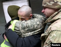 A Ukrainian citizen is welcomed upon his arrival following the exchange of prisoners of war (POWs) between Ukraine and the separatist republics near the Mayorsk crossing point in Donetsk region, Dec. 29, 2019.
