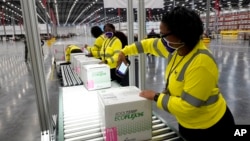 Boxes containing the Moderna COVID-19 vaccine are prepared to be shipped at the McKesson distribution center in Olive Branch, Miss., Sunday, Dec. 20, 2020. (AP Photo/Paul Sancya, Pool)