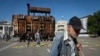 A man passes a burned transformer from a power plant badly damaged in one of Russia's recent missile attacks on energy systems in Kyiv, Ukraine, Sept. 19, 2024. 