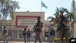 M23 rebels guard outside the South Kivu province administrative office, at the center of east Congo's second-largest city, Bukavu, Feb. 16, 2025.