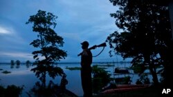 A forest guard keeps vigil at the flooded Kaziranga National Park, east of Gauhati, northeastern Assam state, India, July 26, 2016. 