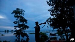 A forest guard keeps vigil at the flooded Kaziranga National Park, east of Gauhati, northeastern Assam state, India, July 26, 2016. 