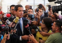 FILE - Venezuelan opposition leader Juan Guaido, who many nations have recognized as the country's rightful interim ruler, talks to the media as he arrives to attend a session of Venezuela's National Assembly in Caracas, Venezuela, Sept. 17, 2019.