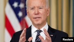 FILE - U.S. President Joe Biden speaks in the State Dining Room at the White House in Washington, March 15, 2021.