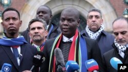 FILE - South Africa's Minister of Justice and Correctional Services Ronald Lamola, center, and Palestinian assistant Minister of Multilateral Affairs Ammar Hijazi, right, address the media outside the ICJ in The Hague, Jan. 11, 2024. 