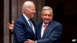 FILE: President Joe Biden is greeted by Mexican President Andres Manuel Lopez Obrador as he arrives at the National Palace in Mexico City, Mexico, Monday, Jan. 9, 2023.