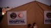 FILE - Rohingya refugee children from Myanmar are seen in front of a Malaysian field hospital near Cox's Bazar, Bangladesh, Jan. 27, 2018. The IFRC has opened two such facilities in Cox's Bazar to help fight the spread of COVID-19.