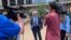 FILE - Defense attorney Earl Gray, center, talks to reporters outside court in downtown Minneapolis after his client, former Minneapolis police Officer Thomas Lane, made his first court appearance in the death of George Floyd, June 4, 2020.