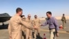 Defense Secretary Mark Esper talks with U.S. troops in front of an F-22 fighter jet deployed to Prince Sultan Air Base in Saudi Arabia, Tuesday, Oct. 22, 2019.