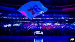 FILE - Philadelphia 76ers mascot Franklin waves the flag during pre-game introductions prior to the NBA basketball game against the Brooklyn Nets, in Philadelphia, Pennsylvania, April 14, 2024.