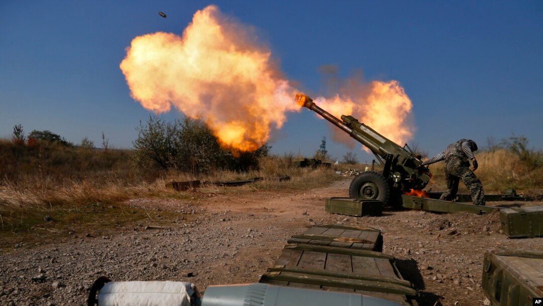 FILE - Pro-Russian rebels fire artillery toward Ukrainian position at Donetsk Sergey Prokofiev International Airport on the outskirts the city of Donetsk, eastern Ukraine, Oct. 14, 2014.