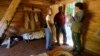 FILE - Ruth Toliner, left, and her husband Lowell Toliner, of Olney, Md., ask Steve Bashore questions about this newly reconstructed slave cabin at George Washington's Mount Vernon estate in Mt. Vernon, Va, Sept. 19, 2007. Scholastic Publishing is recalling one of its children's books from bookstore shelves in the U.S as it may give a false impression of the reality of the lives of slaves.