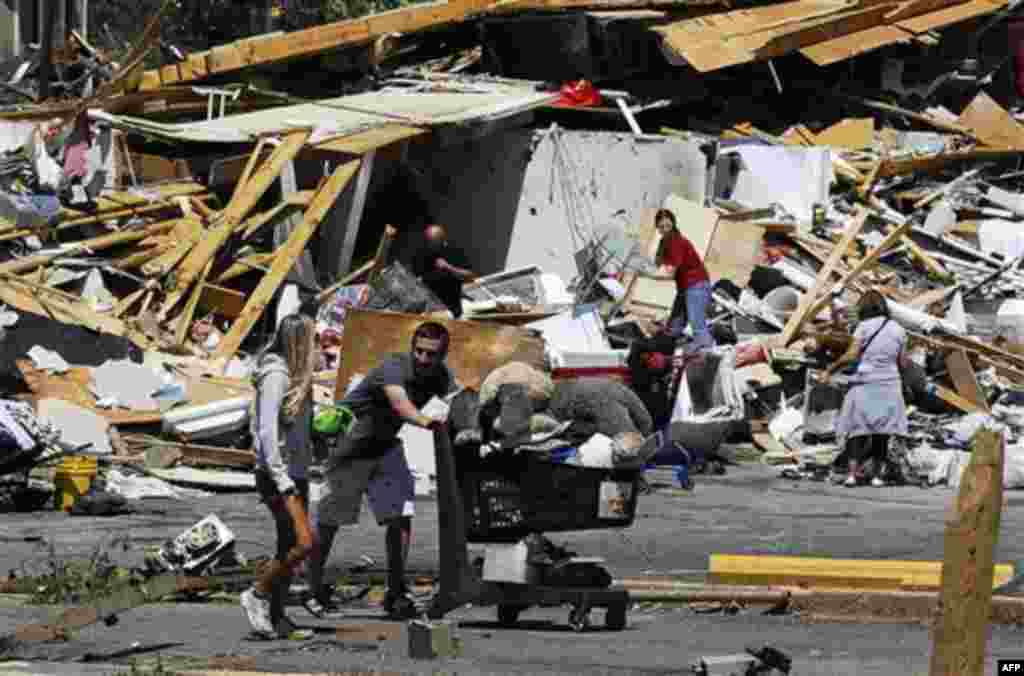 People reclaim some of their belongings in the Alberta City neighborhood Thursday April 28, 2011, after a tornado struck Tuscaloosa, Ala. the day before. Massive tornadoes tore a town-flattening streak across the South, killing at least 269 people in six