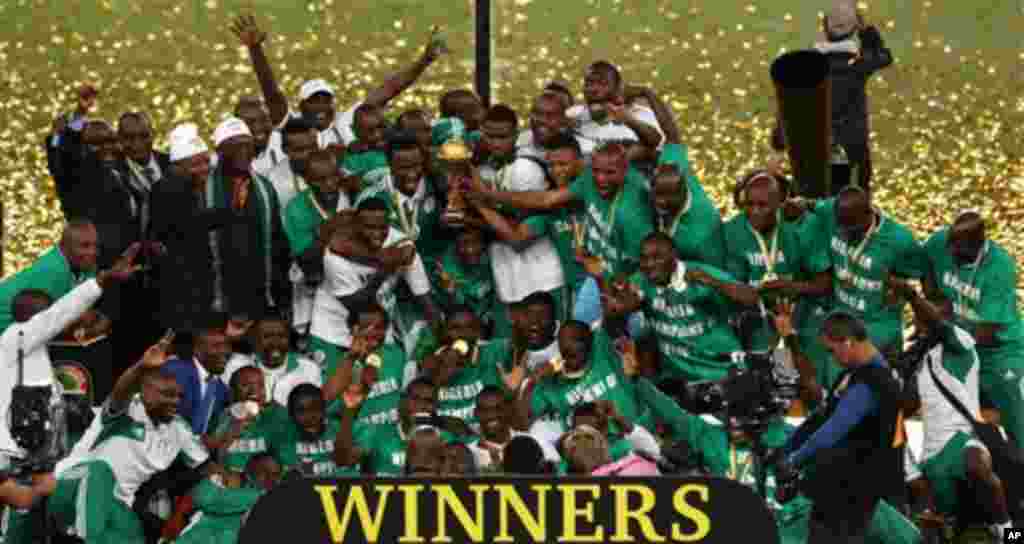 Nigeria's soccer team hold the trophy as they celebrate after winning the African Cup of Nations final soccer match against Burkina Faso at Soccer City Stadium in Johannesburg, South Africa, Sunday Feb. 10, 2013. (AP Photo/Themba Hadebe)