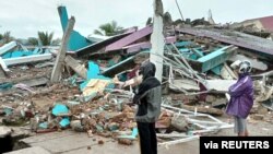People look at a damaged hospital building following an earthquake in Mamuju, West Sulawesi province, Indonesia, Jan. 15, 2021. (Antara Foto/Akbar Tado via Reuters)