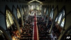 FILE - The Catholic Church officiates a reconciliation mass which seeks to bring together all sectors of the community at the San Mateo cathedral of Osorno, Chile, June 17, 2018.