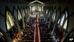 FILE - The Catholic Church officiates a reconciliation mass which seeks to bring together all sectors of the community that had become divided at the San Mateo cathedral of Osorno, Chile, June 17, 2018.