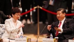 FILE - China's President Xi Jinping, right, and Hong Kong's Chief Executive Carrie Lam talk during the APEC-ASEAN dialogue, on the sidelines of the APEC summit, in Danang, Vietnam, Nov. 10, 2017.