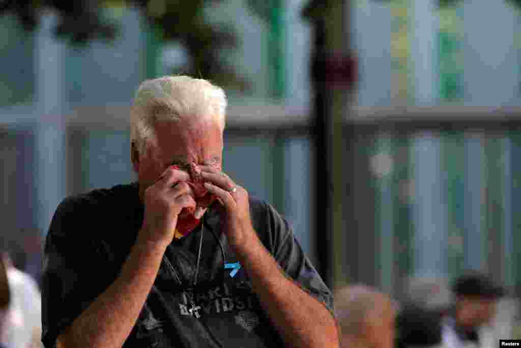 A man wipes away tears during ceremonies commemorating the 18th anniversary of the 9/11 attacks at the 911 Memorial in lower Manhattan in New York, Sept. 11, 2019.