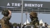 A French soldier, left, salutes an Ivorian soldier as the French soldiers prepare to leave Camp Thomas d'Aquin Ouattara, the former French 43rd Marine Infantry Battalion base in Port-Bouet in Abidjan on Feb. 20, 2025.