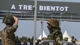 A French soldier, left, salutes an Ivorian soldier as the French soldiers prepare to leave Camp Thomas d'Aquin Ouattara, the former French 43rd Marine Infantry Battalion base in Port-Bouet in Abidjan on Feb. 20, 2025.