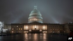 FILE - The U.S. Capitol in Washington is shrouded in mist.