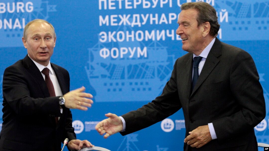 FILE - Russian President Vladimir Putin, left, and Germany's former Chancellor Gerhard Schroeder attend an economic forum in St.Petersburg, Russia, June 21, 2012. 