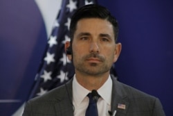 FILE - Acting Secretary of Homeland Security Chad Wolf listens during a press conference in Tegucigalpa, Honduras, Jan. 9, 2020.