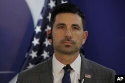 FILE - Acting Secretary of Homeland Security Chad Wolf listens during a press conference in Tegucigalpa, Honduras, Jan. 9, 2020.