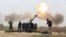 FILE - Iraqi security forces fire at Islamic State militants positions from villages south of the Islamic State group-held city of Mosul, Iraq. 