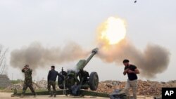 FILE - Iraqi security forces fire at Islamic State militants positions from villages south of the Islamic State group-held city of Mosul, Iraq. 