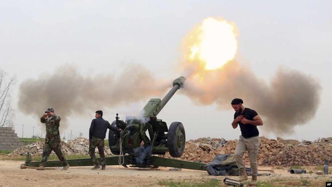 Pasukan keamanan Irak menembakka roket ke arah militan ISIS dari desa di sebelah selatan kota Mosul yang dikuasai ISIS di Irak (26/3).