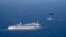 An Israeli military naval ship and an Israeli air force helicopter operate next to a cruise ship off the coast of Haifa, northern Israel, April 25, 2013. 