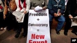 Egyptian protesters at a rally demanding Libyan leader Moammar Gadhafi step down during demonstrations in Tahrir Square in Cairo, Feb. 25, 2011