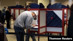 People cast their ballots for the upcoming presidential election as early voting begins in Cincinnati, Ohio, Oct. 6, 2020. 