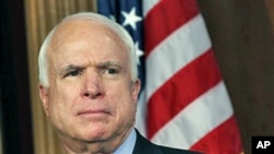 Senator John McCain listens during a news conference to discuss a Congressional resolution condemning the government of Syria for crimes against humanity and supporting the right of the people of Syria to be safe and to defend themselves, on Capitol Hill 