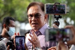 FILE - Malaysia opposition leader Anwar Ibrahim speaks to media members.