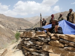 FILE - Armed men who are against Taliban uprising stand at their check post, at the Ghorband District, Parwan province, Afghanistan, June 29, 2021.