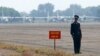 FILE - A Vietnamese soldier stands guard in front of military aircraft near a dioxin contaminated area while then-U.S. Defense Secretary Jim Mattis visits Bien Hoa air base in Bien Hoa, outside Ho Chi Minh City, Oct. 17, 2018. 