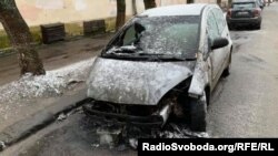 FILE - The burnt car of RFE/RL journalist Halyna Tereshchuk in is seen on a street in Lviv, western Ukraine. 