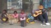 John Madubeko and some members of his family performing outside a Gweru shop in Zimbabwe's Midlands province. (Photo: Sam Zaranyika)