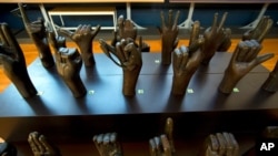 FILE - A sculpture of hands signing the alphabet is seen at Gallaudet University museum in Washington, Dec. 11, 2019. 