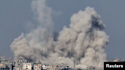 Smoke rises over Gaza, amid the ongoing conflict between Israel and the Palestinian Islamist group Hamas, as seen from southern Israel, December 8, 2023. 