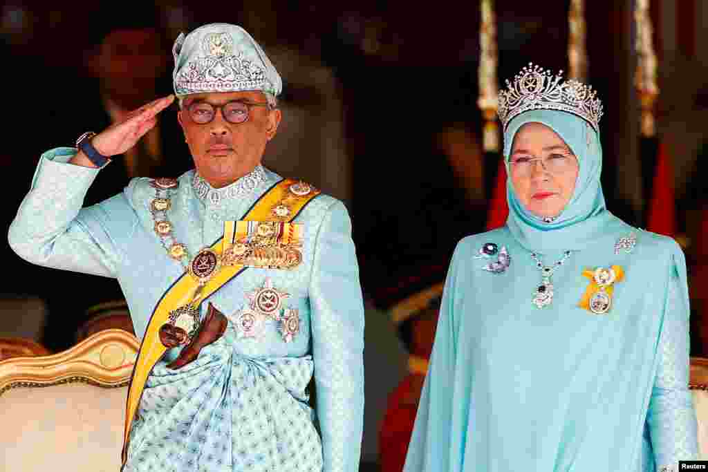 Malaysia&#39;s new King Sultan Abdullah Sultan Ahmad Shah and Queen Tunku Azizah Aminah Maimunah attend a welcoming ceremony at the Parliament House in Kuala Lumpur.