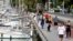 People walk on the Palma de Mallorca sea promenade during hours in which individual exercise is now permitted outdoors, for the first time since Spain went on a nationwide coronavirus lockdown, in Palma de Mallorca, Spain, May 2, 2020. 
