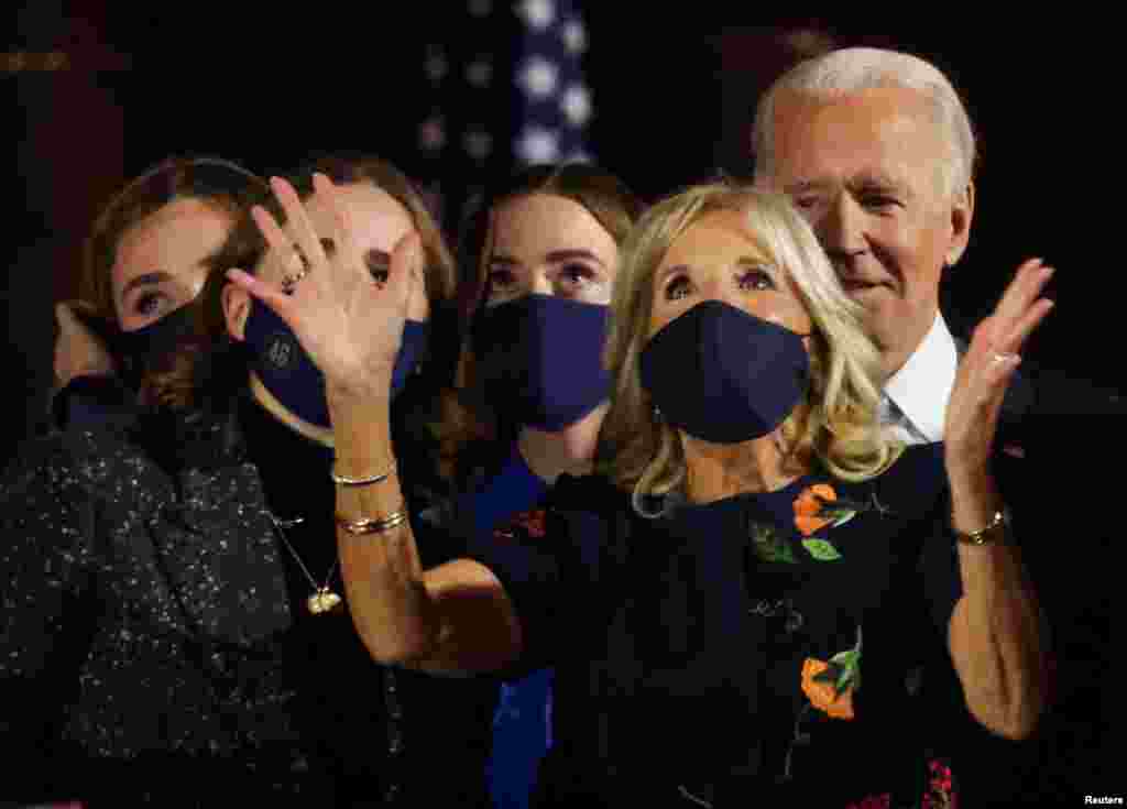 Democratic 2020 U.S. presidential nominee Joe Biden is accompanied on stage by his wife Jill and his granddaughters after speakig during his election rally.